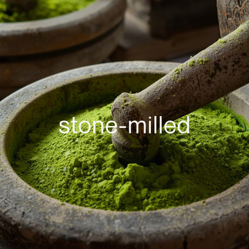 a traditional granite stone mill grinding tencha into matcha, with text overlay: "stone-milled"