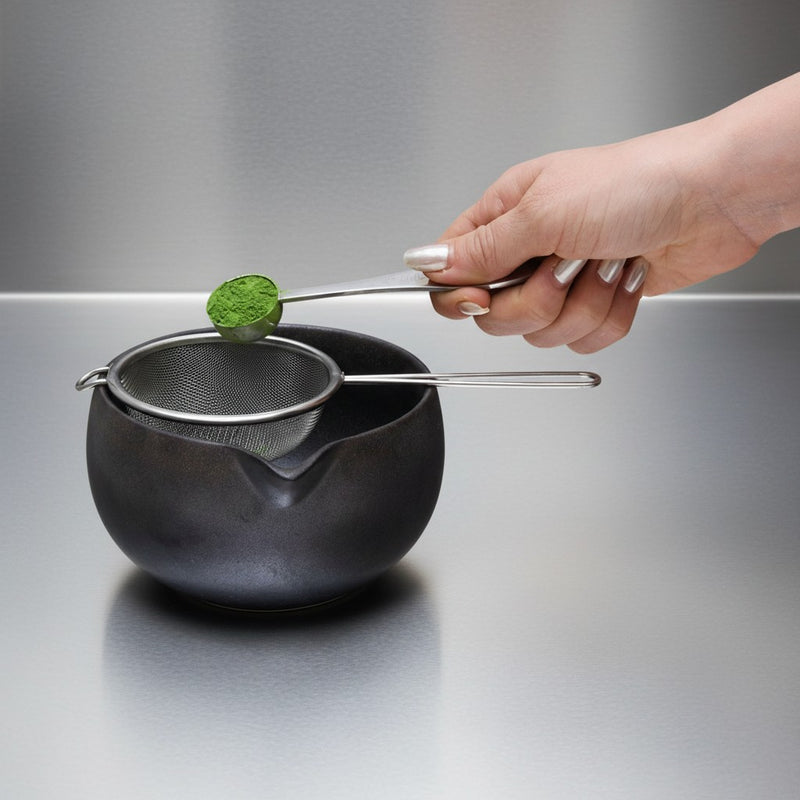 step 1: sifting NO. 1 matcha through a fine-mesh sifter into a ceramic bowl, the first step of the ritual